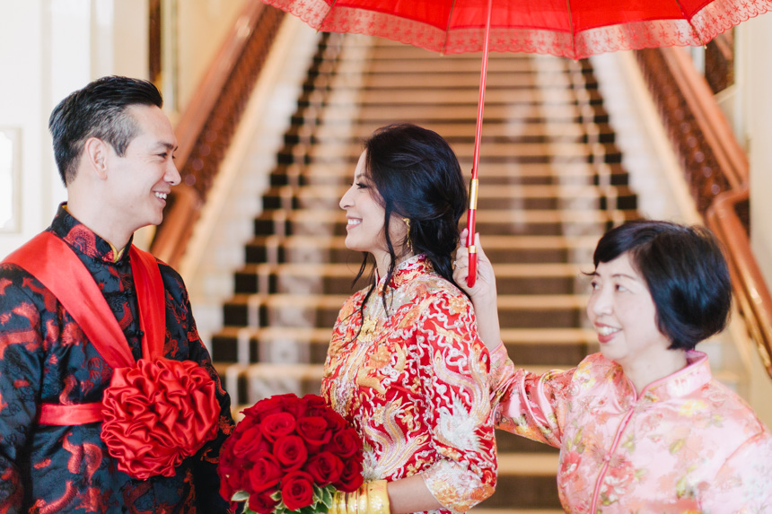 The Repulse Bay Wedding bride and groom under a red umbrella at their The Repulse Bay wedding
